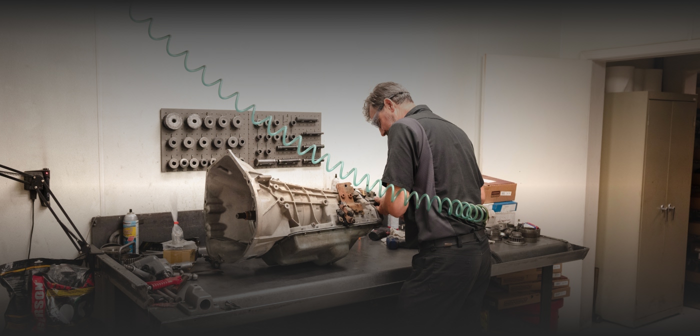 photo of mechanic working on a transmission