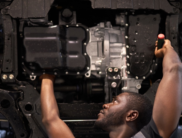 mechanic checking transmission