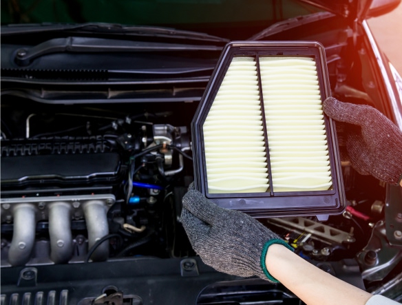 photo of mechanic holding an air filter