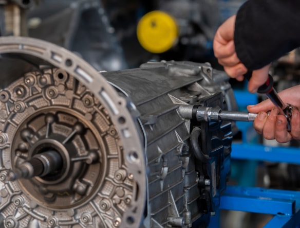 mechanic releasing a bolt from a transmission