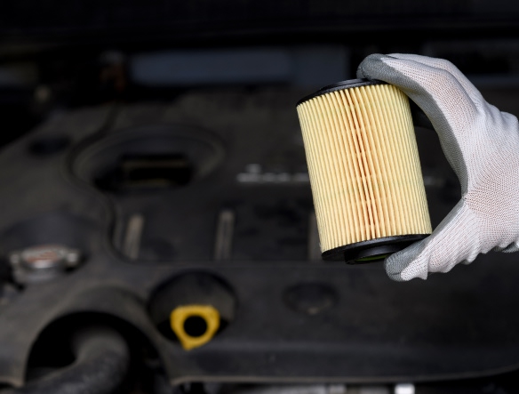 mechanic holding oil filter